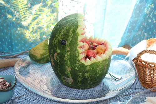 Cut a watermelon to look like a shark. Fill it with fruit salad.