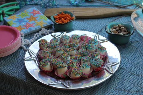 Dip marshmallows in candy coating and top with sprinkles.